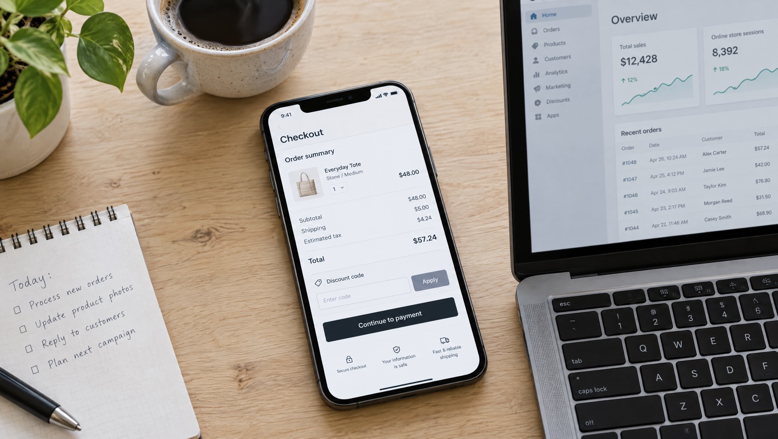 Phone showing a Shopify-style checkout with a discount code field and an order summary, next to a laptop with a store admin open on a desk